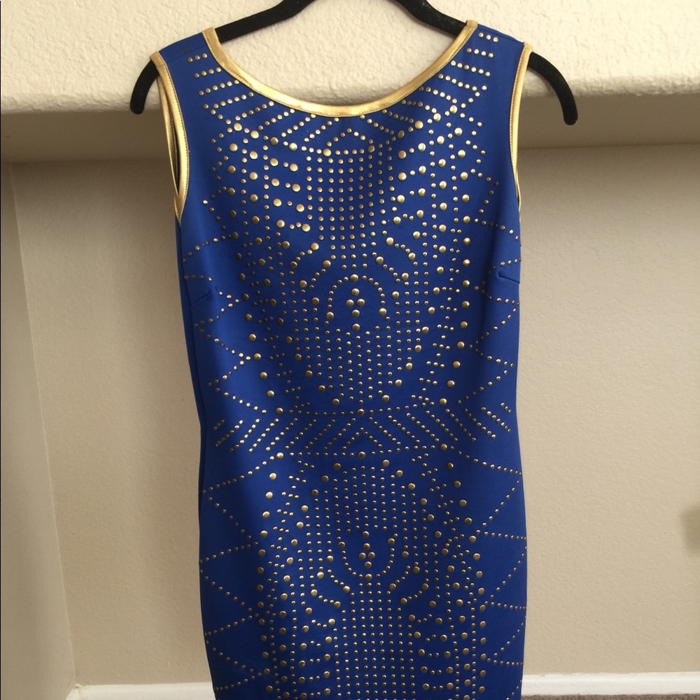 Dress, cobalt blue and gold studs. Above the knee.